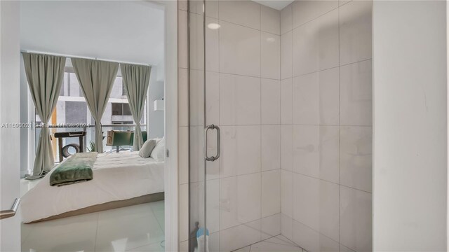 bathroom with tile patterned flooring and a shower with shower door