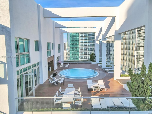 view of pool with a hot tub