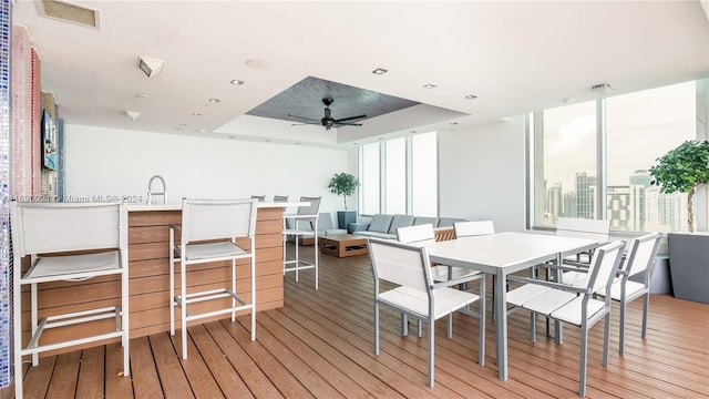 interior space featuring outdoor lounge area, a bar, and ceiling fan