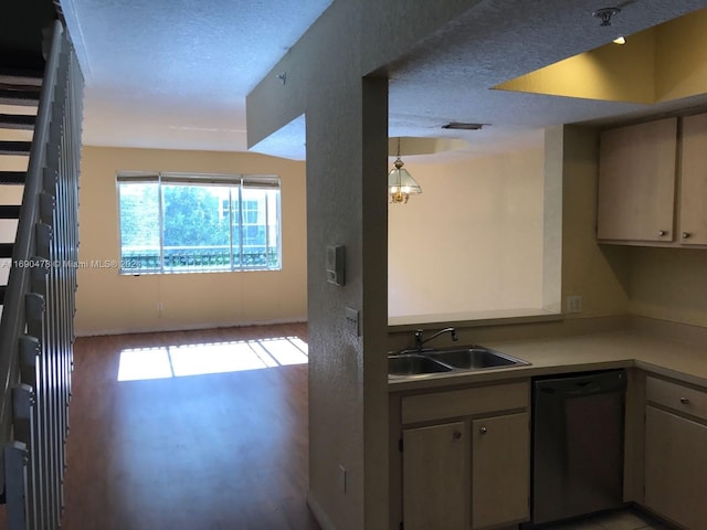 kitchen featuring black dishwasher, light hardwood / wood-style floors, a textured ceiling, and sink