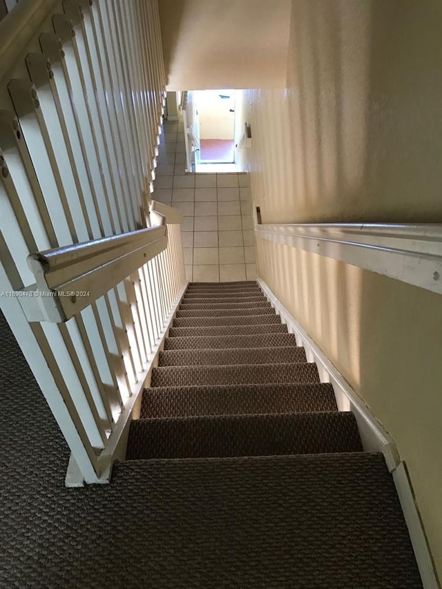 stairs with tile patterned floors