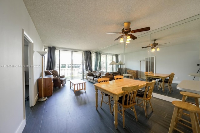 dining area with dark wood-type flooring, expansive windows, and a textured ceiling