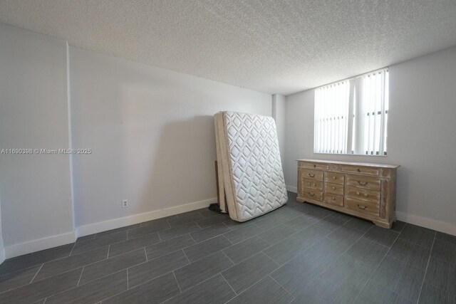 unfurnished bedroom featuring a textured ceiling