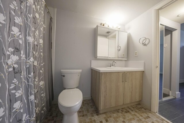 bathroom featuring vanity, toilet, and a shower with shower curtain