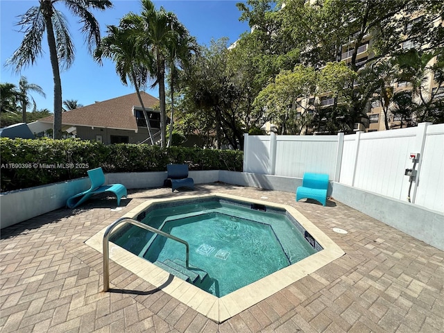 view of swimming pool with an in ground hot tub and a patio area