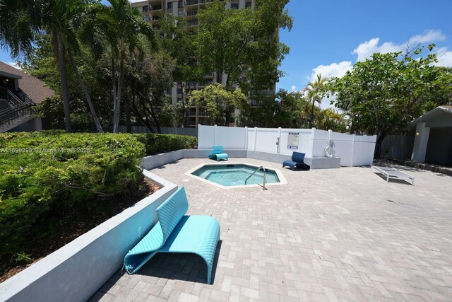 view of swimming pool with a hot tub and a patio