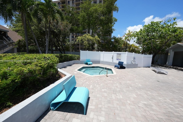 view of pool featuring a patio area, a hot tub, and fence