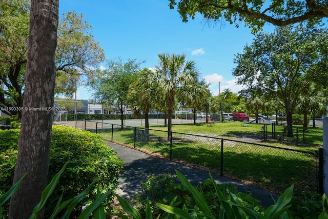 surrounding community with fence and a lawn