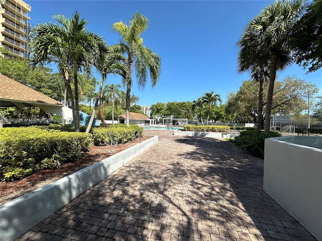 view of property's community with a swimming pool and fence