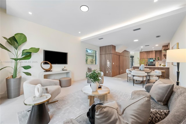 living room featuring visible vents and recessed lighting