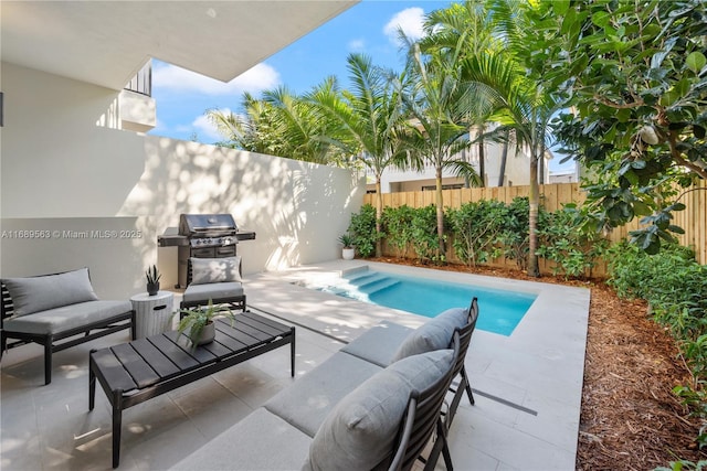 view of pool with a patio area, a fenced backyard, a fenced in pool, and a grill