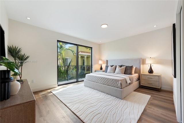 bedroom featuring hardwood / wood-style floors and access to outside