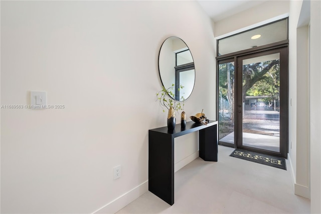 foyer featuring baseboards