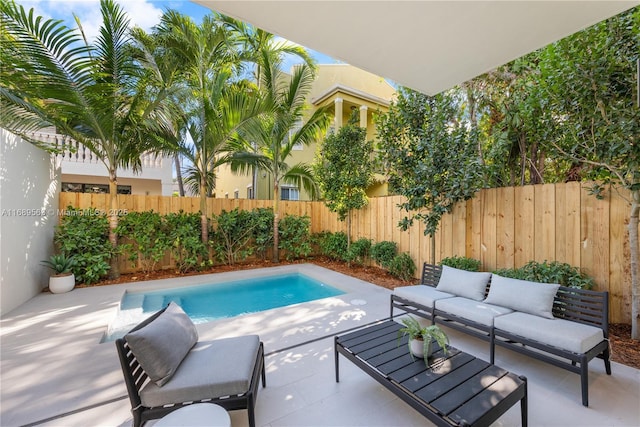 view of pool featuring a fenced in pool, a fenced backyard, a patio, and an outdoor living space