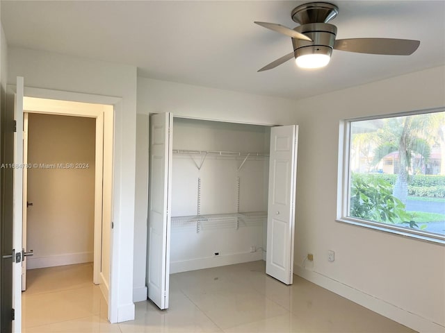 unfurnished bedroom featuring light tile patterned floors, ceiling fan, and a closet