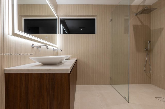 bathroom featuring vanity and tiled shower