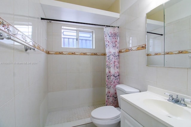 bathroom featuring walk in shower, vanity, tile walls, and toilet