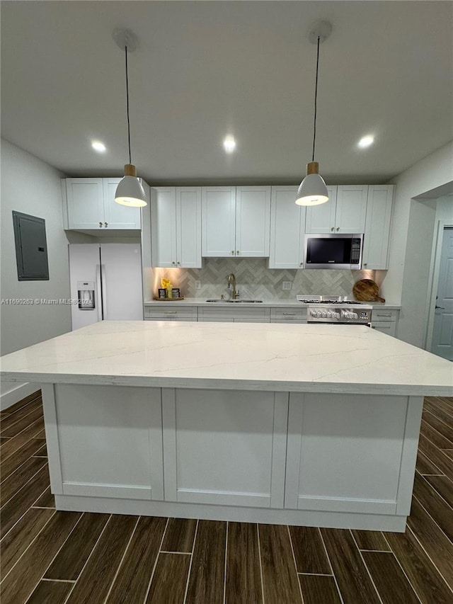 kitchen featuring electric panel, dark hardwood / wood-style flooring, white cabinets, and stainless steel appliances