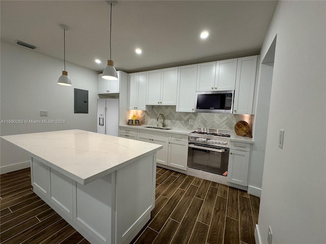 kitchen with white cabinetry, sink, stainless steel appliances, dark hardwood / wood-style flooring, and electric panel