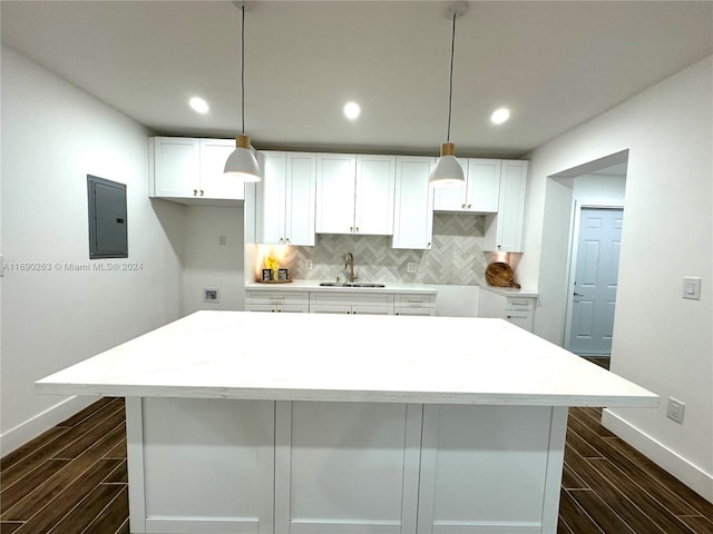 kitchen featuring white cabinetry, sink, electric panel, and dark wood-type flooring