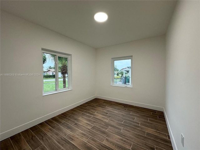 unfurnished room featuring dark hardwood / wood-style floors