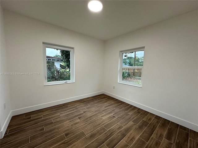 empty room with dark hardwood / wood-style floors