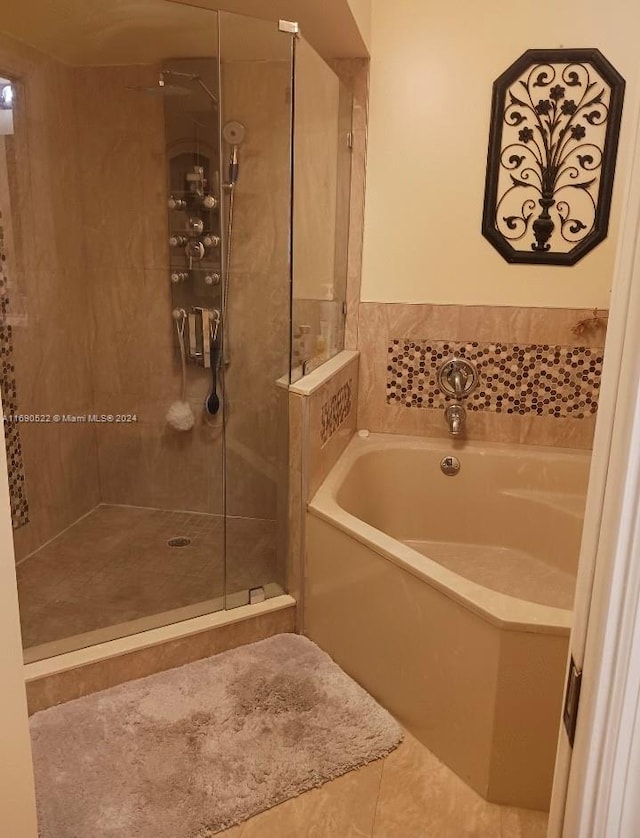 bathroom featuring shower with separate bathtub and tile patterned floors