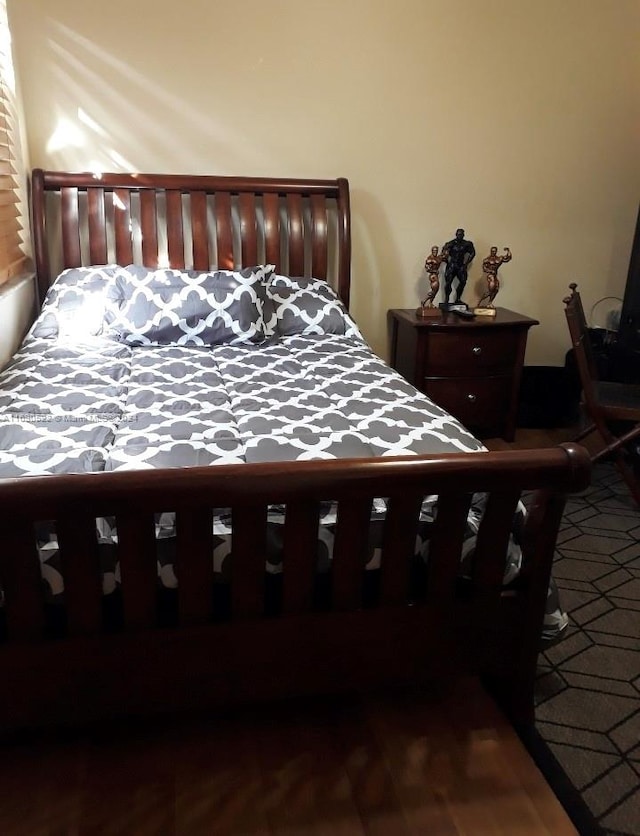 bedroom with hardwood / wood-style flooring