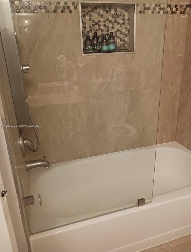 bathroom featuring tiled shower / bath and tile patterned floors