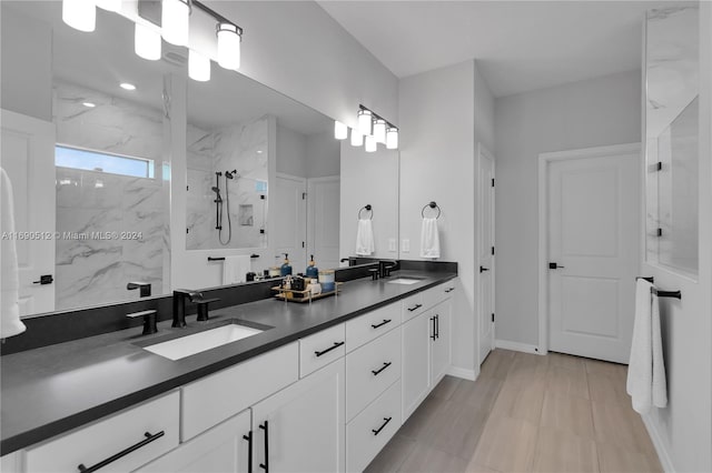 bathroom featuring vanity and tiled shower