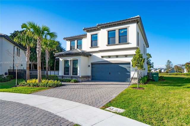 mediterranean / spanish-style house featuring a front lawn and a garage