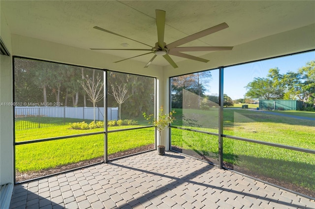 unfurnished sunroom featuring ceiling fan