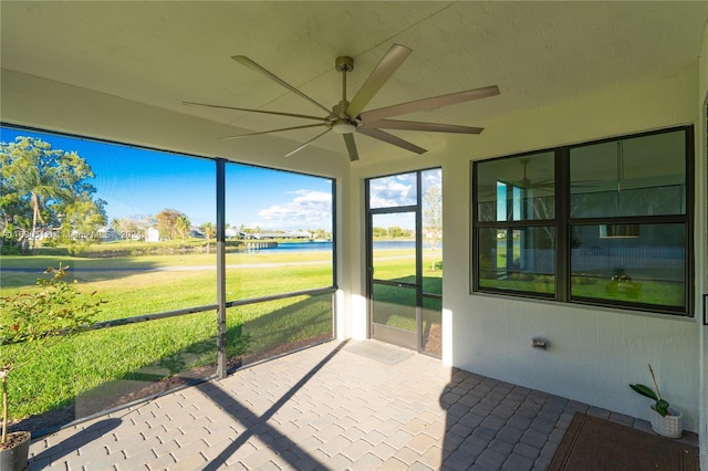 unfurnished sunroom with ceiling fan