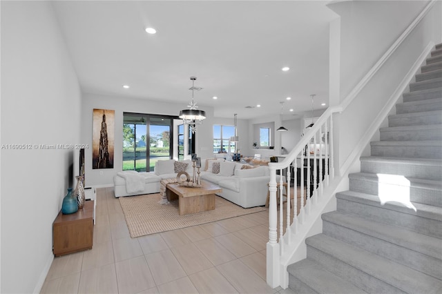 living room with a chandelier and light tile patterned flooring