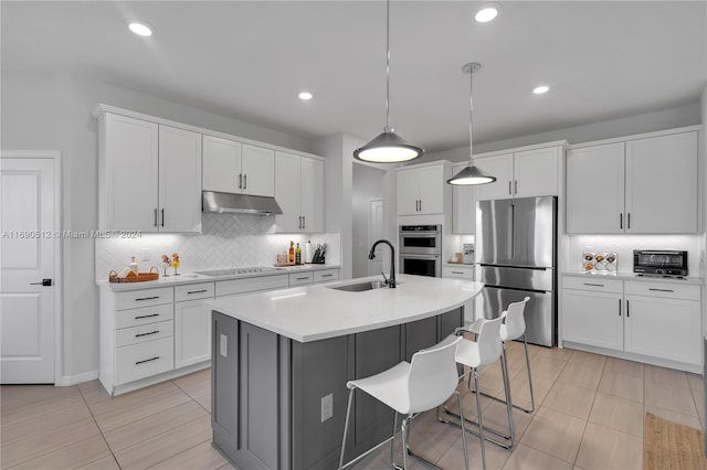 kitchen with white cabinetry, sink, a center island with sink, and appliances with stainless steel finishes