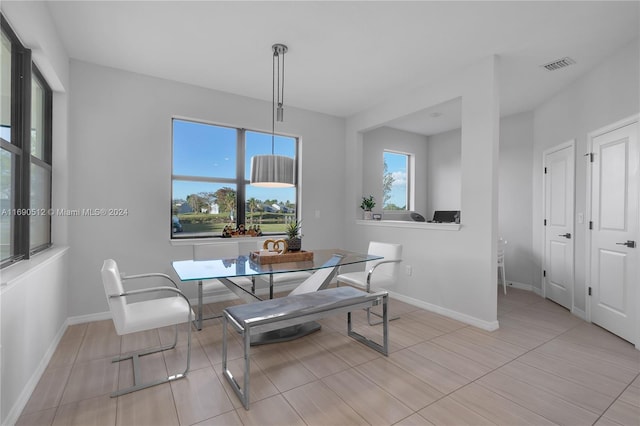 tiled dining space with breakfast area and a healthy amount of sunlight