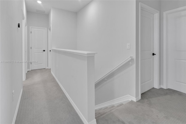 hallway with light colored carpet