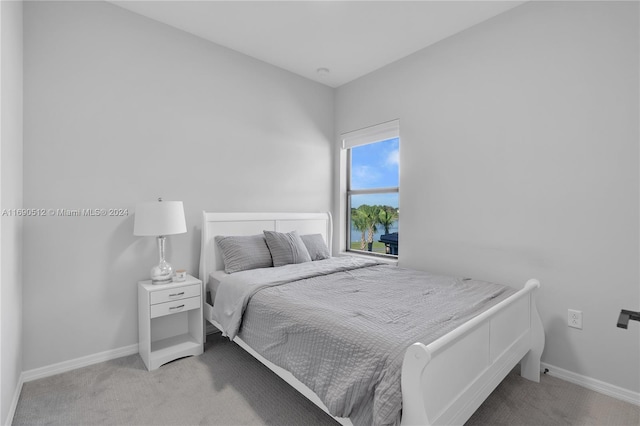 bedroom featuring light colored carpet