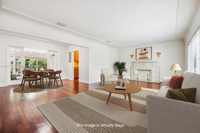 living room featuring dark hardwood / wood-style floors and a premium fireplace