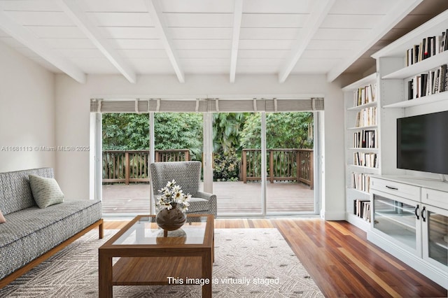 living room featuring beamed ceiling and wood-type flooring