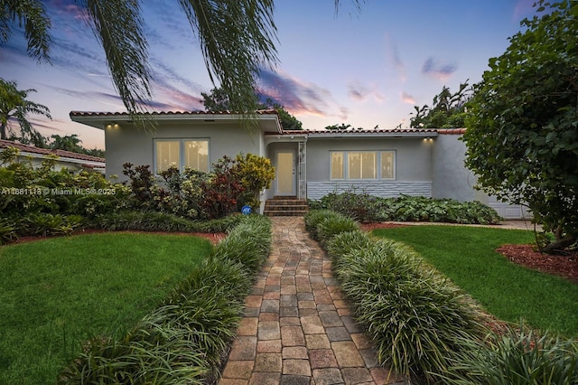 view of front of home with a lawn