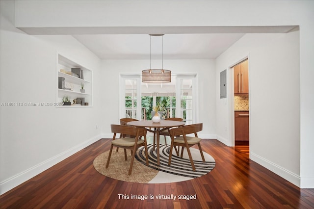 dining room with built in shelves and dark hardwood / wood-style flooring