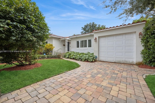 view of front facade with a garage and a front lawn