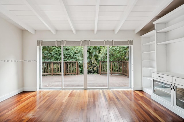 interior space featuring beamed ceiling and hardwood / wood-style flooring