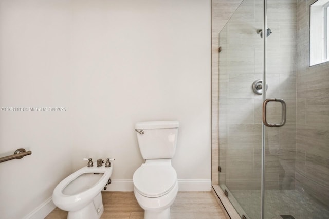 bathroom with toilet, a shower with door, and a bidet