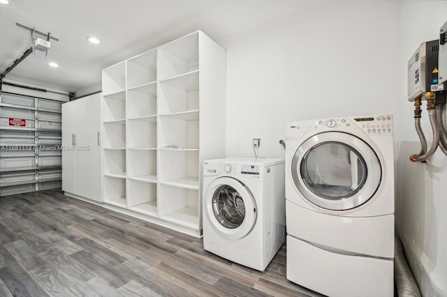 laundry area featuring wood-type flooring and independent washer and dryer