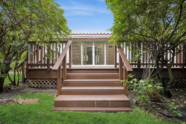 exterior space with a sunroom and a wooden deck