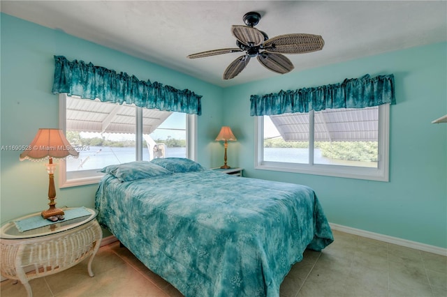 bedroom with light tile patterned floors and ceiling fan