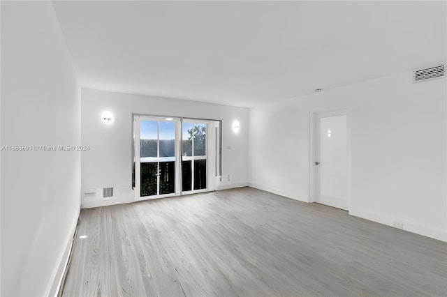 unfurnished room with hardwood / wood-style flooring