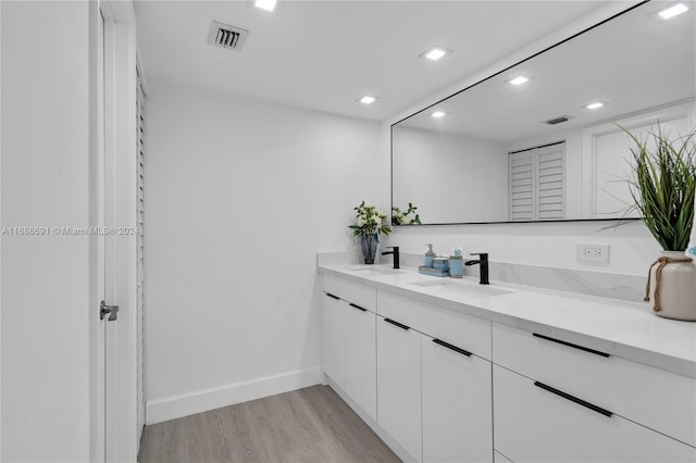 bathroom with hardwood / wood-style floors and vanity